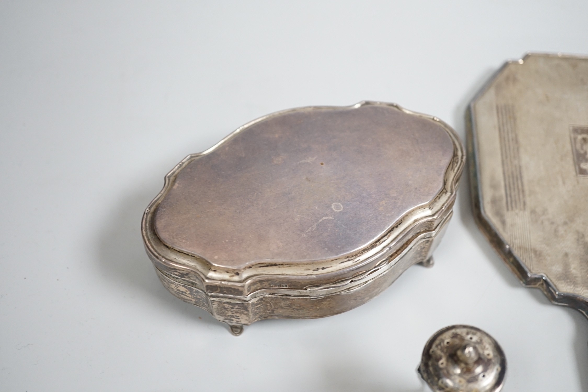 A George V silver mounted trinket box, Elkington & Co, Birmingham, 1918, 13.1cm, a silver mustard pot, two Scandinavian 925 condiments, two silver mounted scent bottles, hatpins and hatpin stand and a silver mounted thre